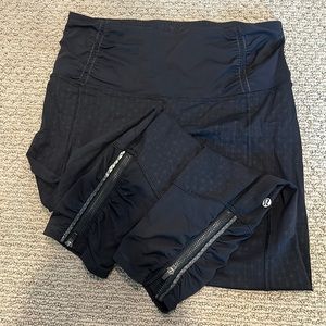 Lululemon leggings, zippers on leg with small geometric pattern.